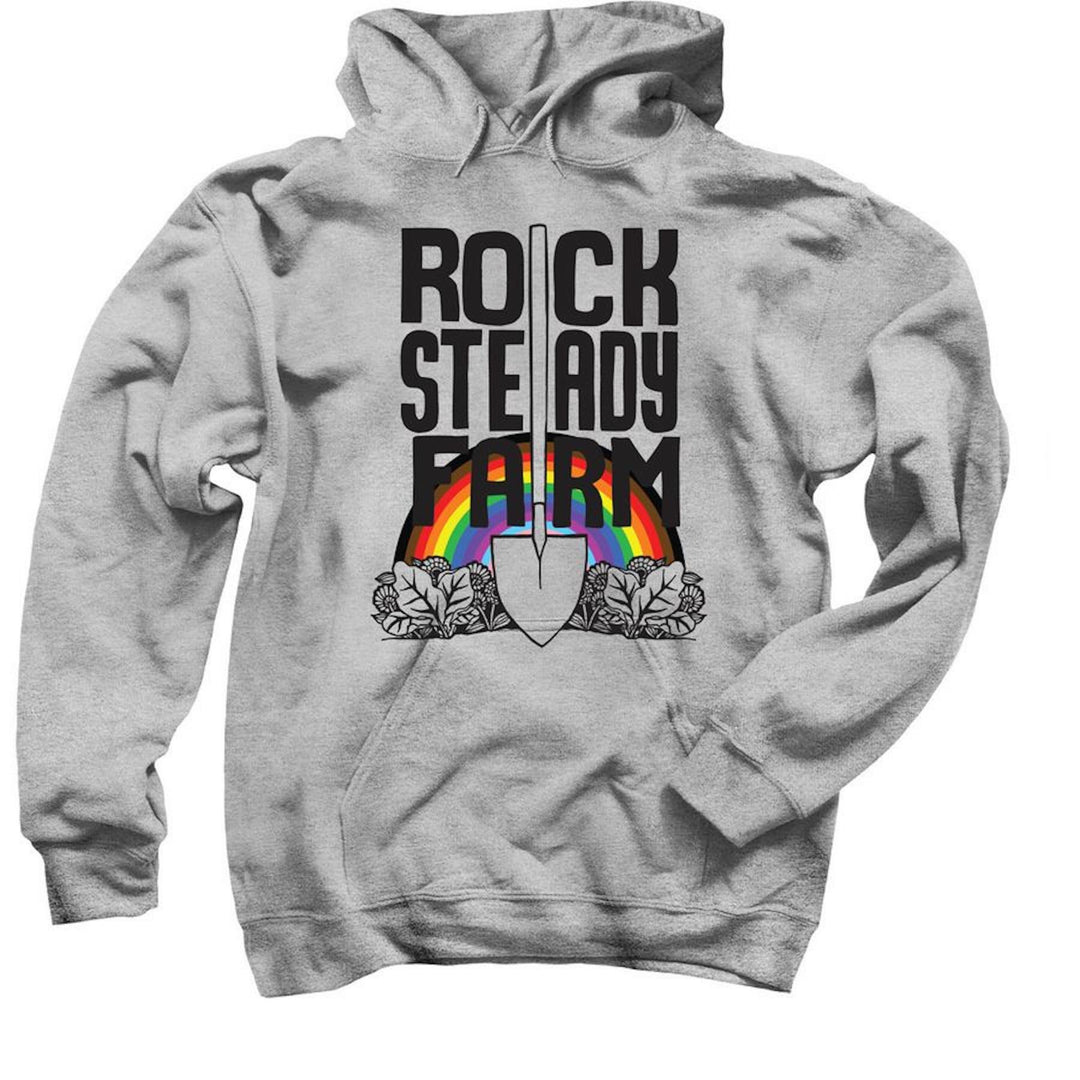 A grey hoodie with a rainbow, shovel and the words "Rock Steady Farm" on it