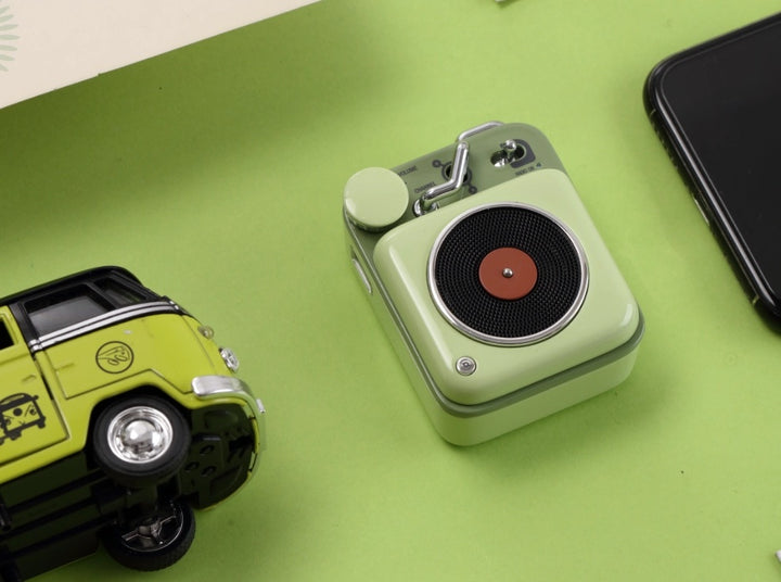 A light green colored record player styled bluetooth
