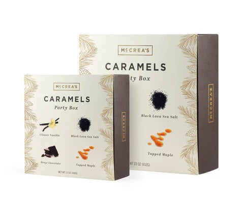 Two boxes of artisan caramel stand next to each other.