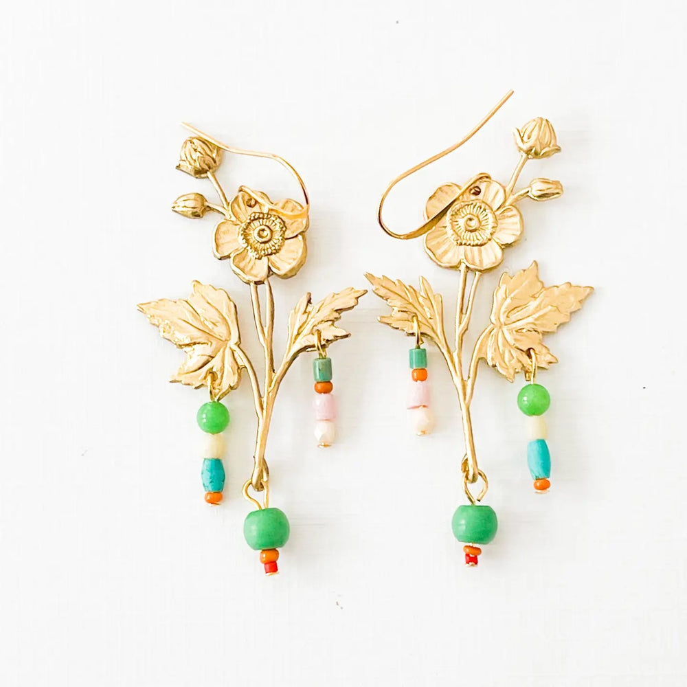 Floral shaped gold colored earrings with colorful beads dangling.