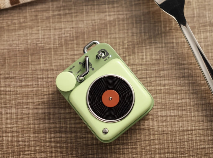 A light green colored record player styled bluetooth